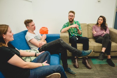 Four people sat on sofas engaging in a group session at a headspace centre
